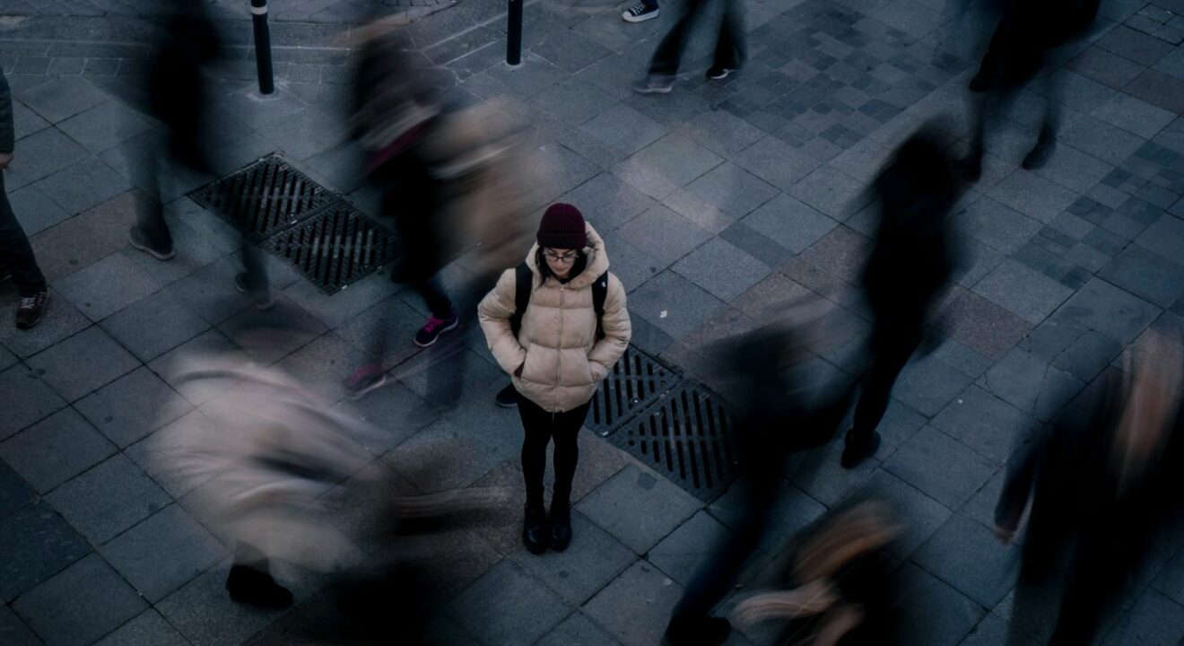 woman standing alone in crowd