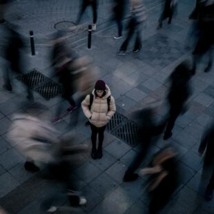 pexels photo 14936616 woman standing alone in crowd