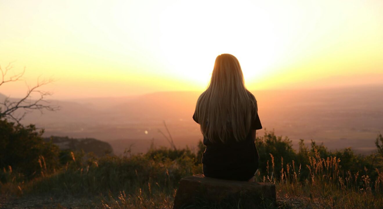 woman looking at sunset