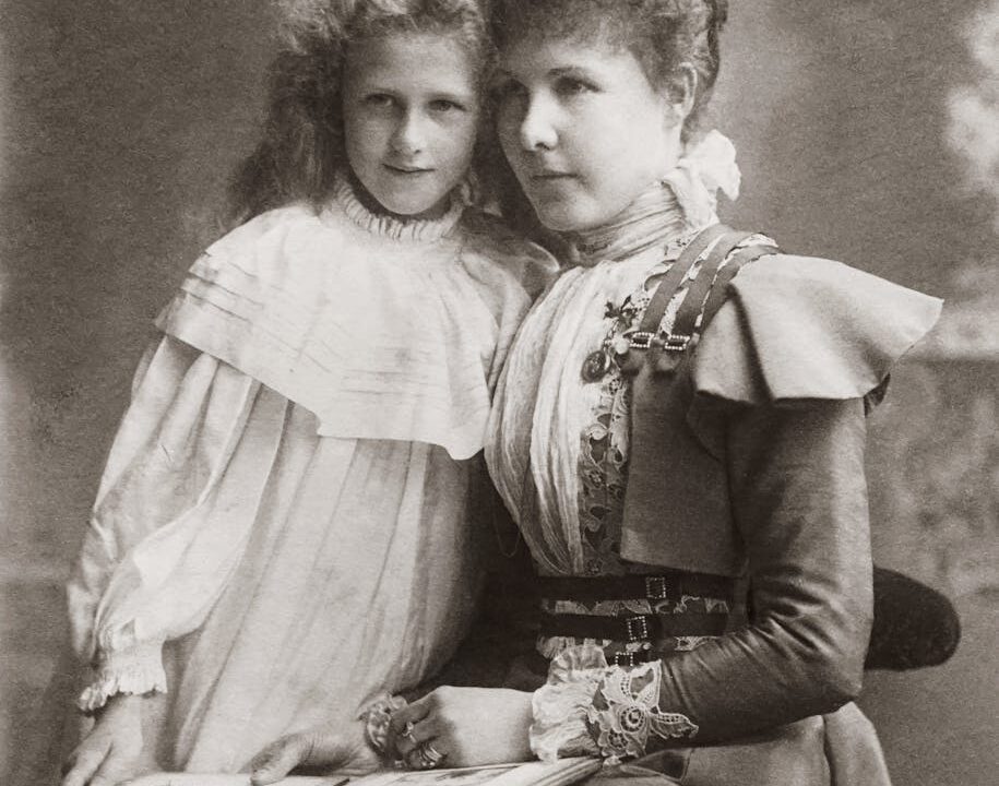 pexels photo 3104394 vintage photo of mother sitting with a photo album beside her child