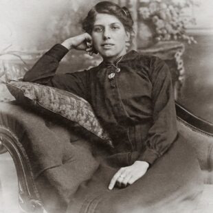 woman in black button up long sleeve shirt sitting on sofa