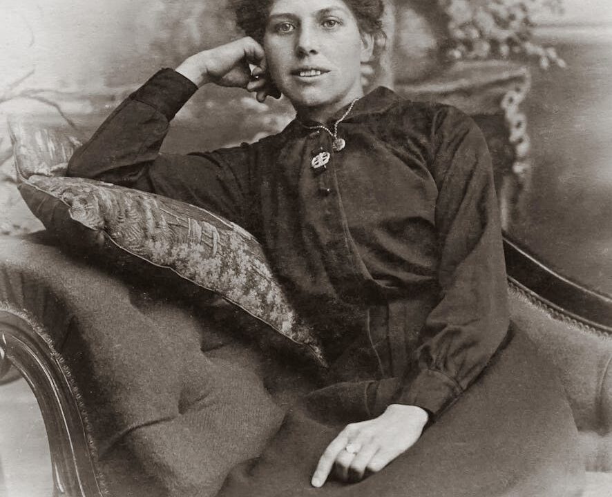 woman in black button up long sleeve shirt sitting on sofa